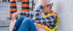 Overwhelmed construction worker taking a break