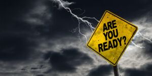 Traffic sign with the words, “Are you ready?” displayed, with dark clouds and a lightening strike in the background.